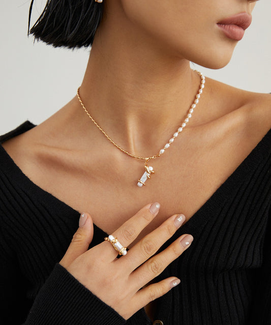 A model wearing a baroque pearls necklace, complemented by a pearl ring.