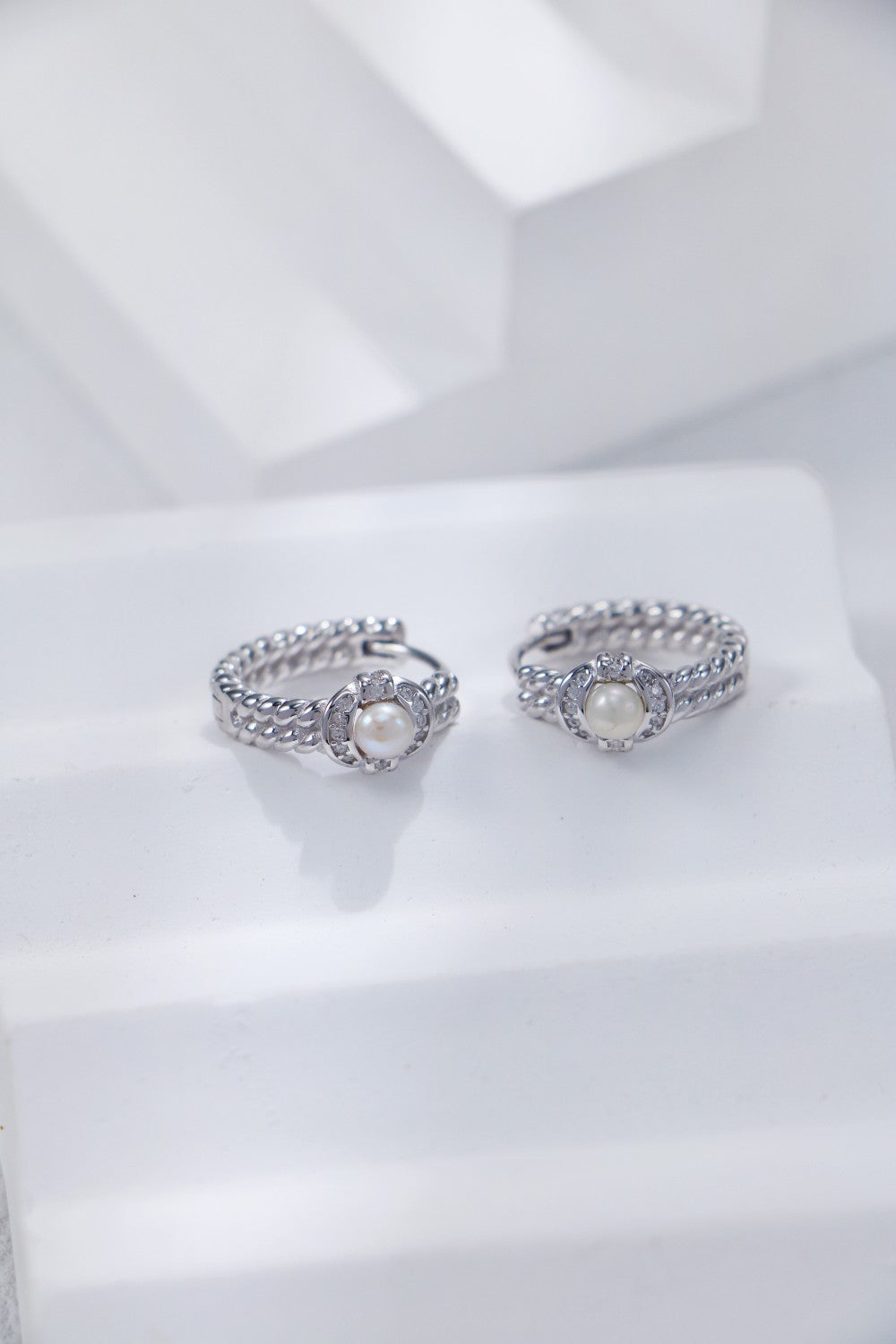 A pair of Mezuille's S925 Silver pearl hoops, in silver and zirconia on white background.