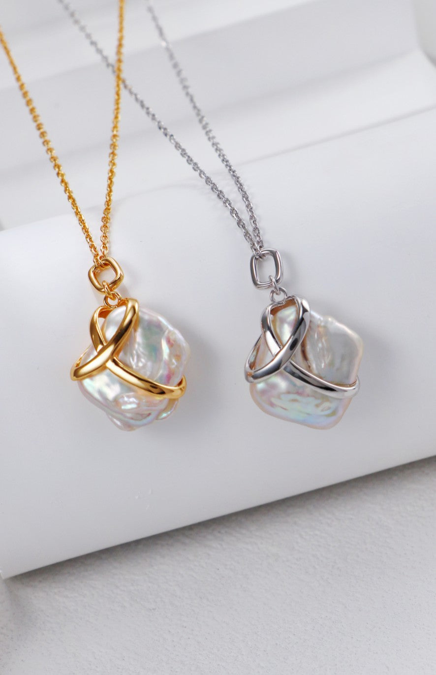 Baroque pearl pendant necklace featuring two different colored pearls, elegantly designed, available in silver and gold.
