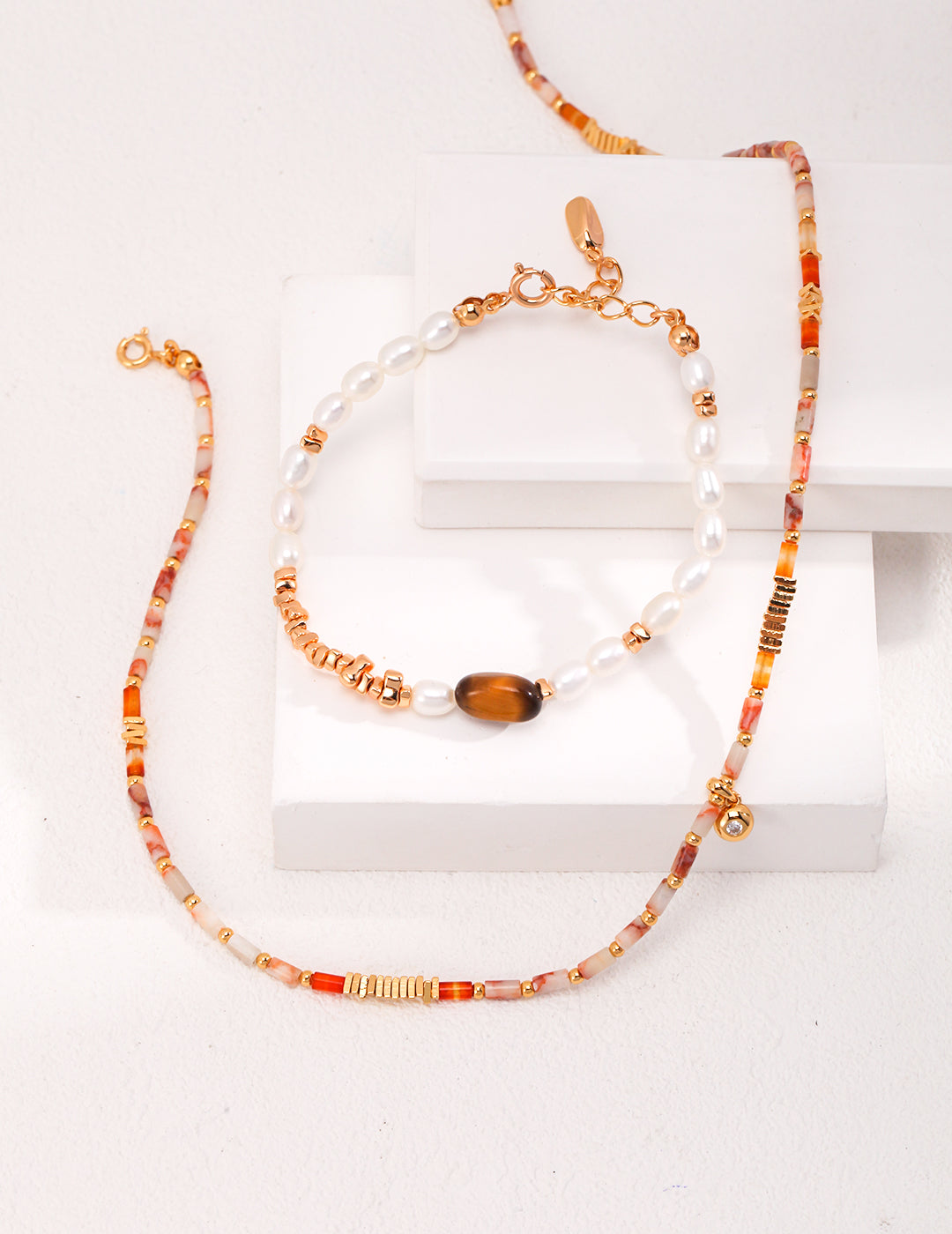 Accessorize with this chic bracelet adorned with gold and orange stone, a great match for colourful gemstone necklace and tiger's eye bracelet.