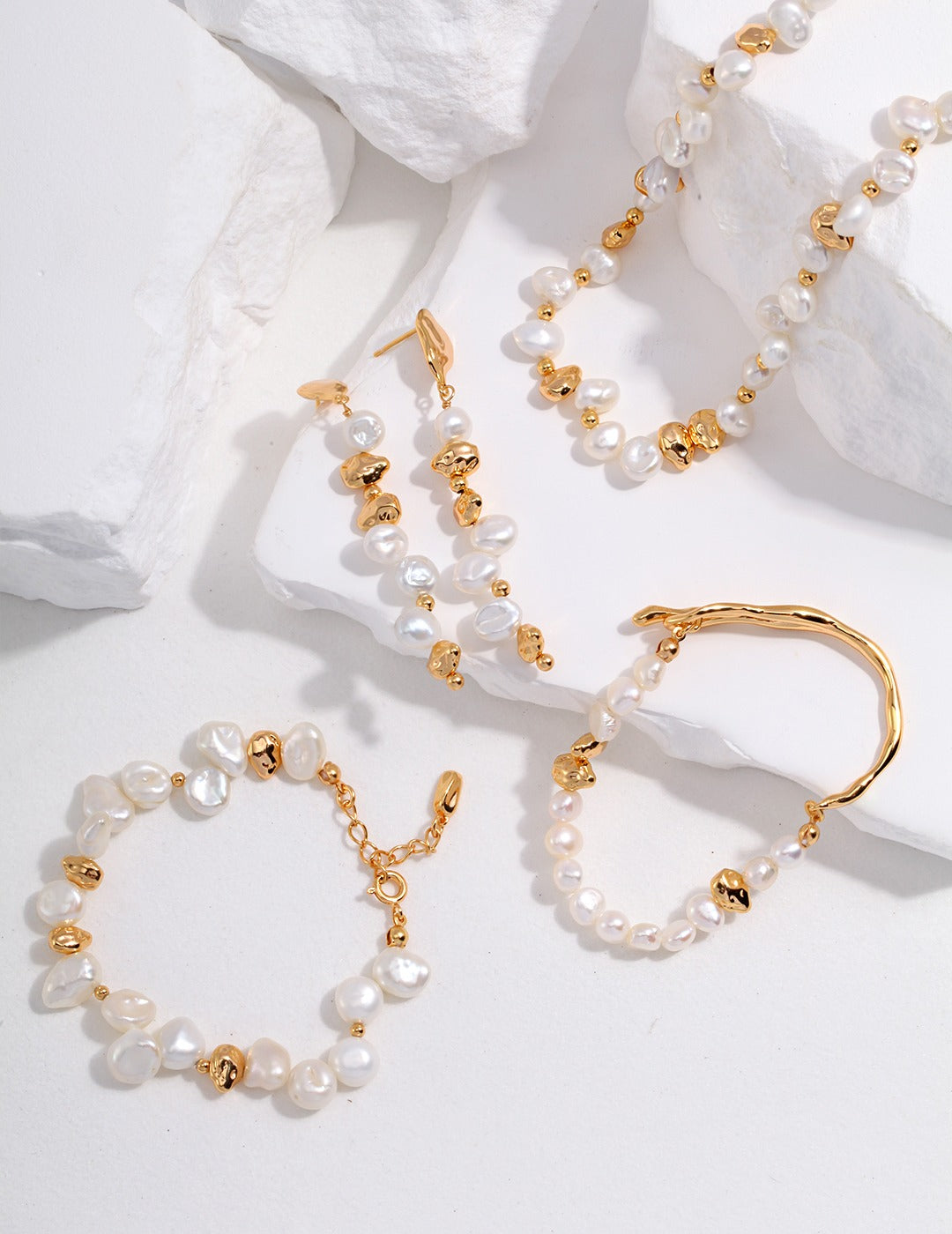 Stunning pearl-accented gold necklace, bracelet, and earrings set.