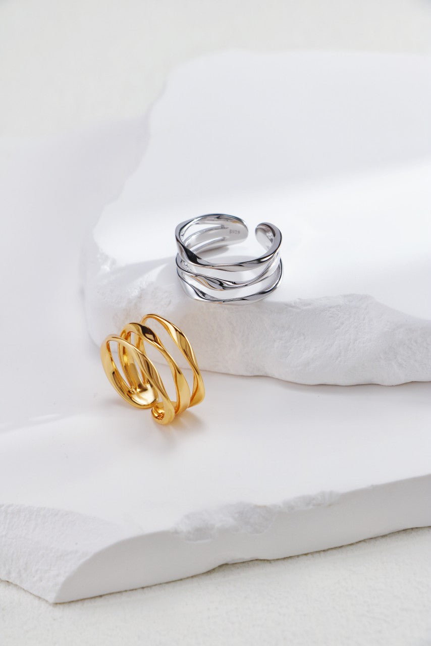 Two stylish open triple layer rings with gold and silver plating, highlighting a unique and modern design.