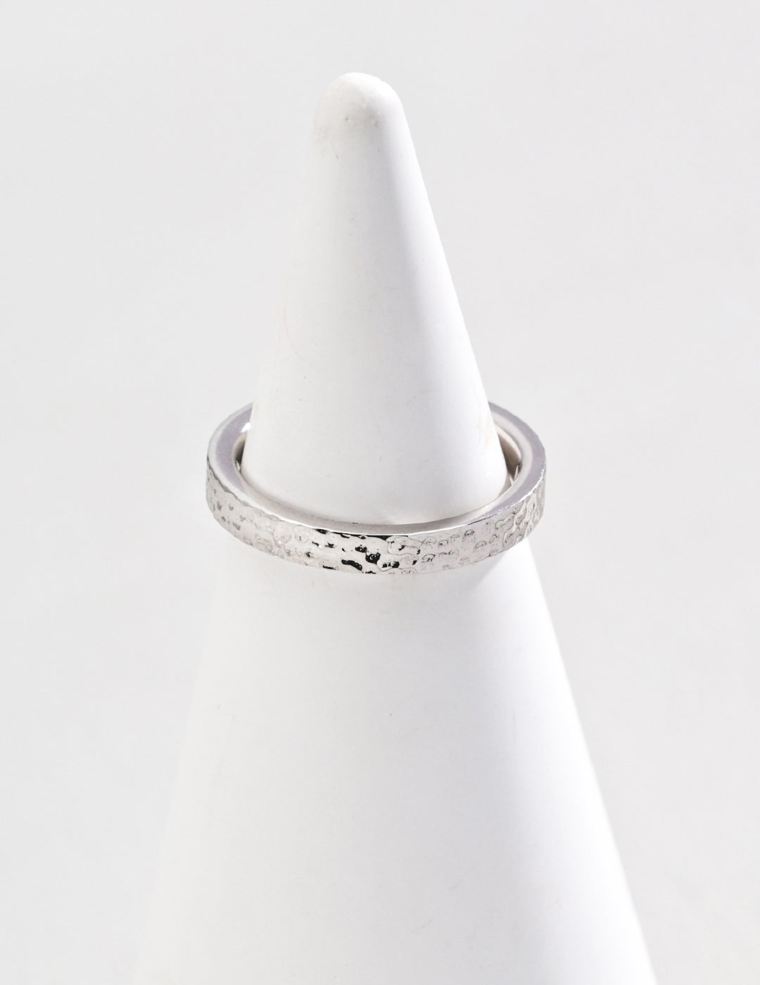 Elegant silver ring with a textured finish, exuding a sleek and modern aesthetic for a timeless look.