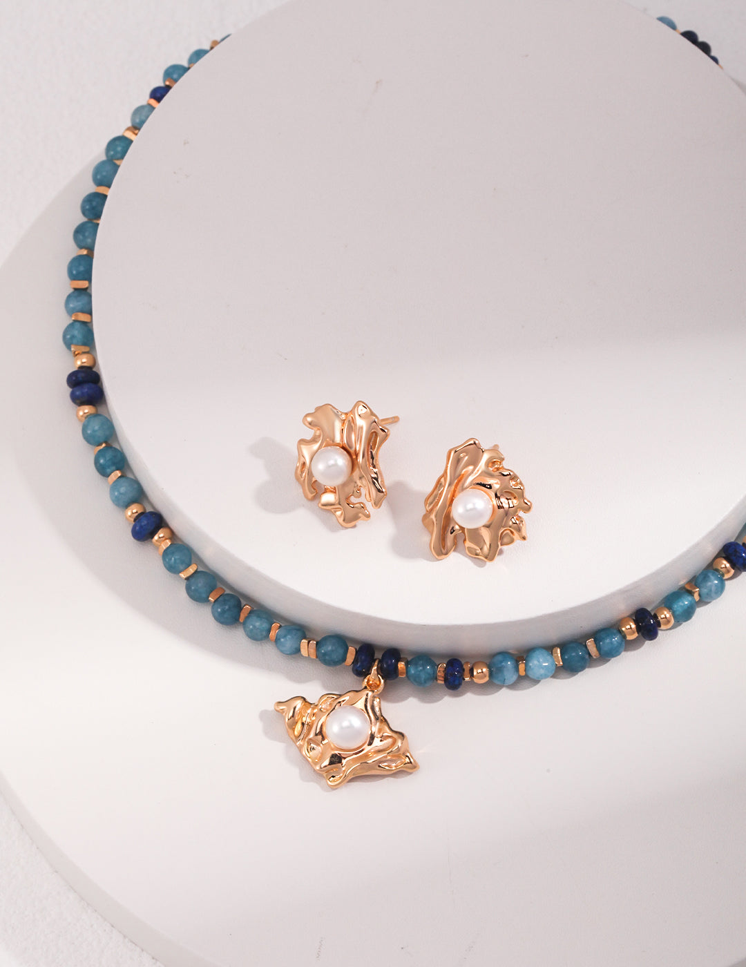 Stunning necklace and earrings set adorned with blue beads, amazonite, and lapis lazuli on gold plated sterling silver.