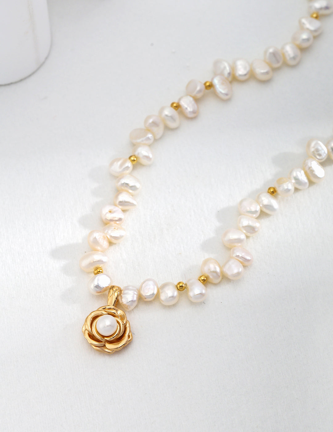 Elegant gold plated camellia pendant necklace, adorned with freshwater pearls