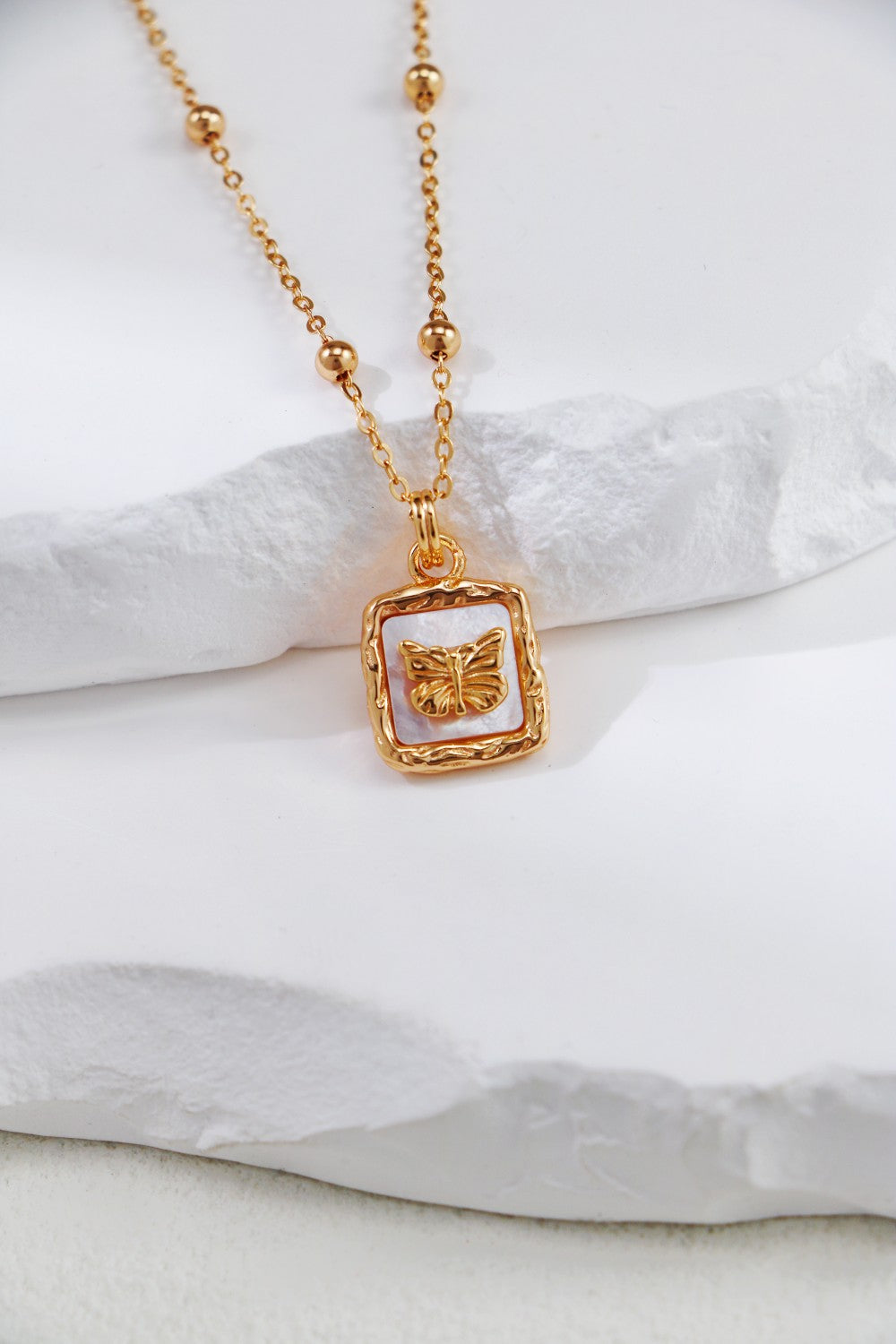 Elegant gold-plated necklace adorned with a nacre butterfly, perfect for adding a touch of sophistication.