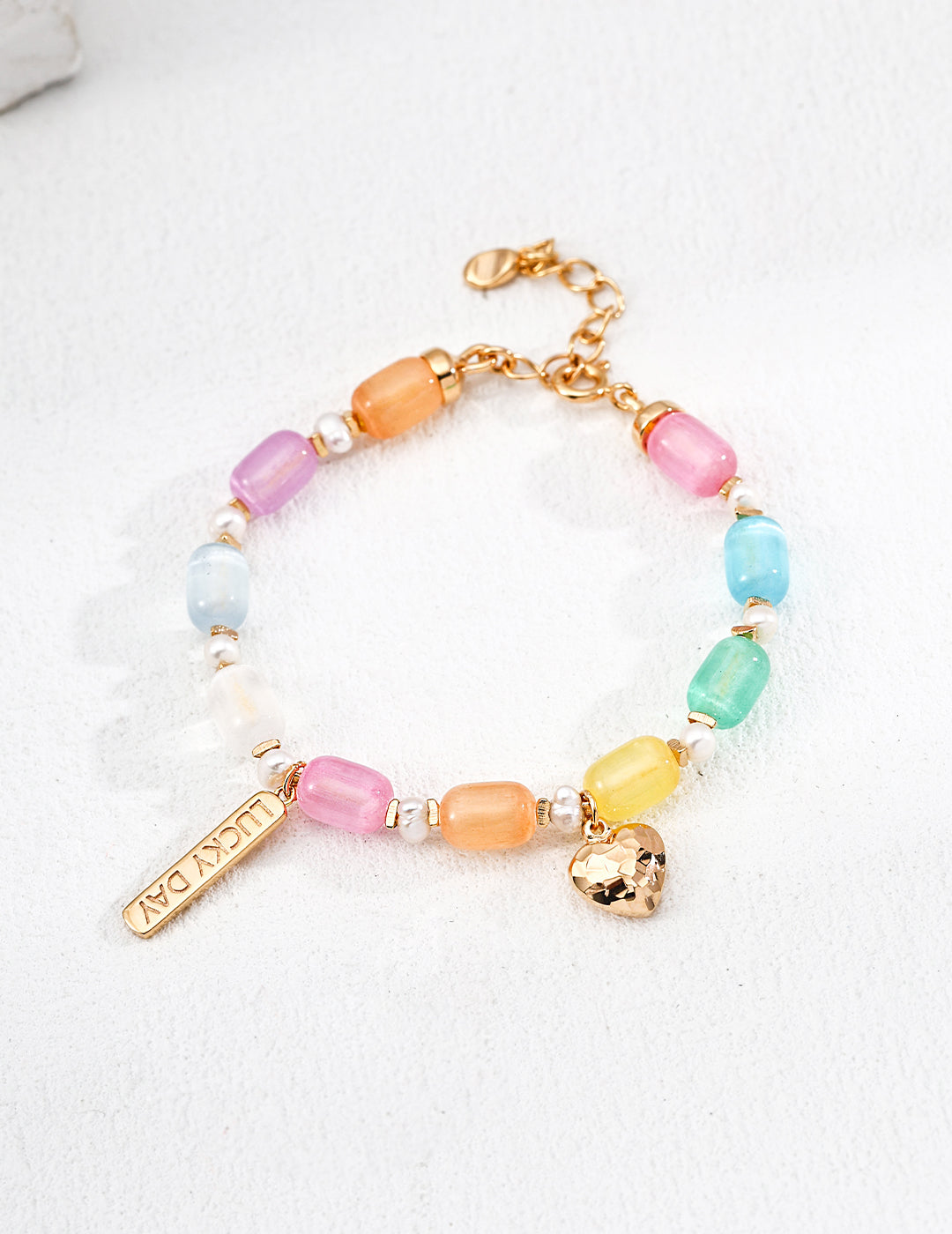 Vibrant rainbow cat's eye bead bracelet showcasing a playful design.