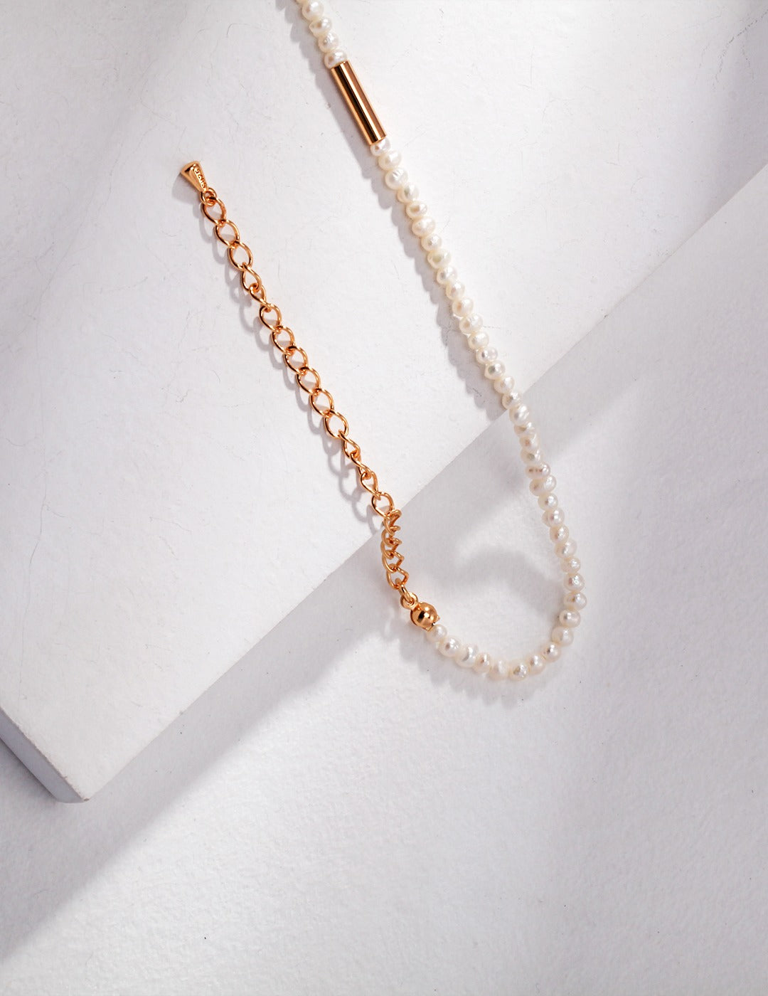 Elegant gold chain featuring a beautiful pearl necklace, perfect for adding a touch of class to any outfit.
