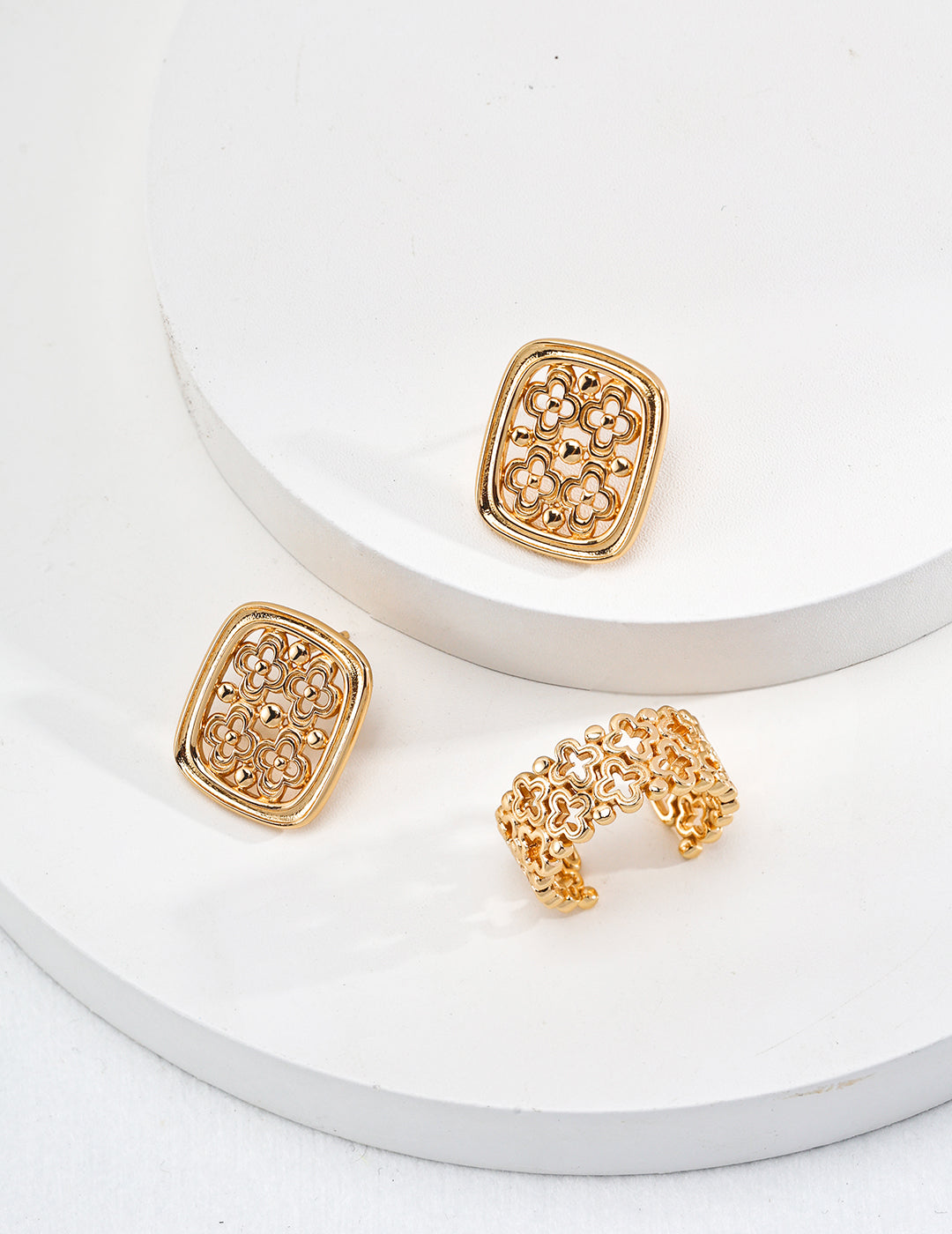 Elegant gold-tone earrings and a ring with a hollow clover design, crafted from s925 silver, showcasing vintage Chinese style.