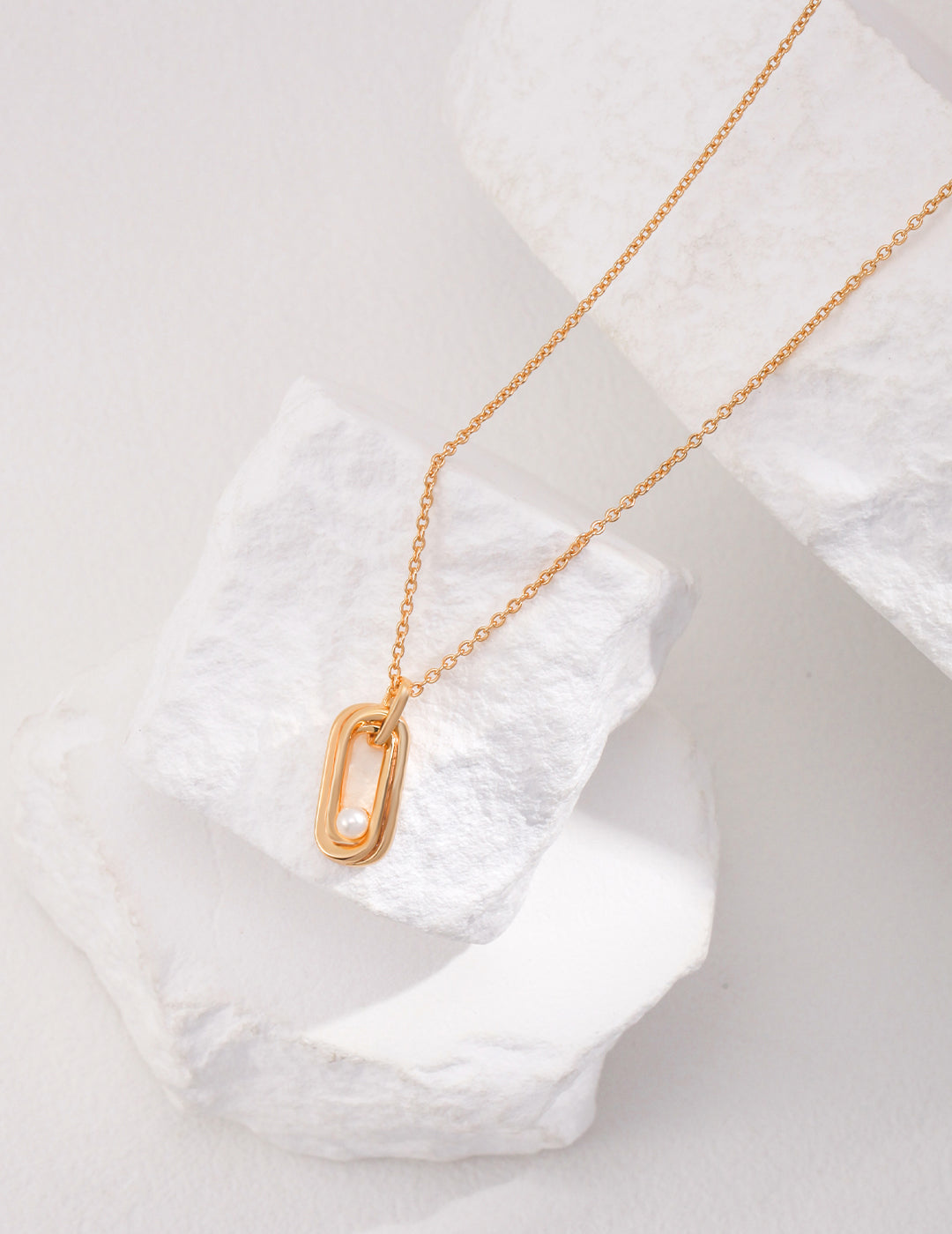 Gold plated necklace with a delicate gold letter pendant and a lustrous gold freshwater pearl.