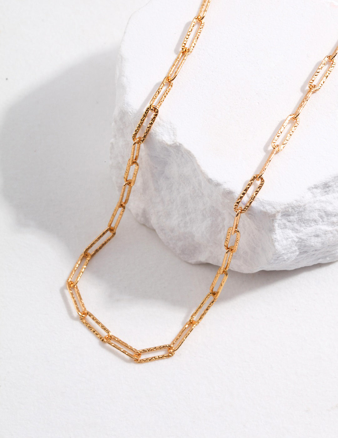 A stylish gold chain link necklace.