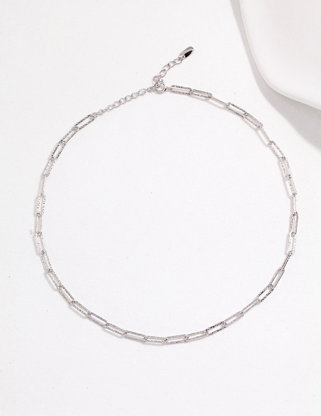 Stylish silver chain necklace with white plate detail.