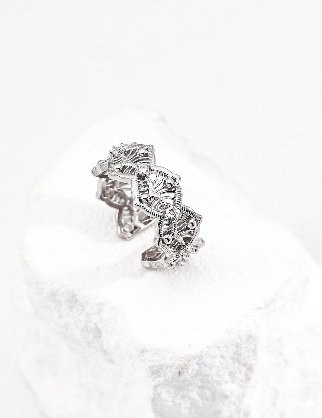 A close-up view of a silver ring adorned with cubic zirconia, showcasing an elegant, princess-like aesthetic.