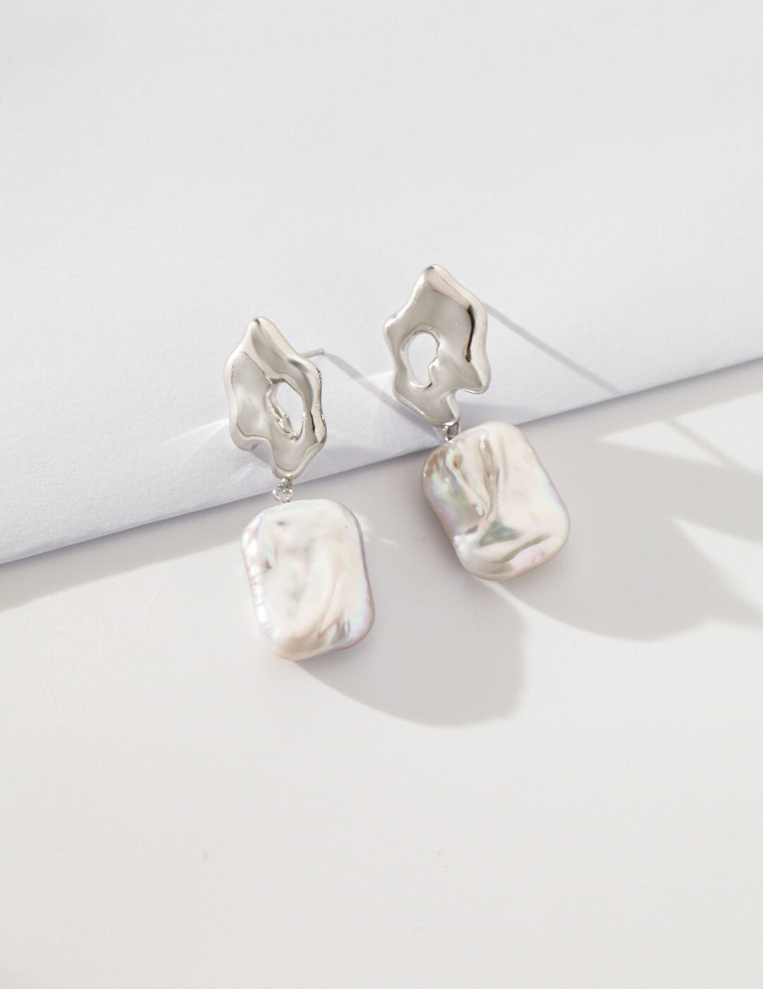 Silver baroque pearls earrings with elegant design.