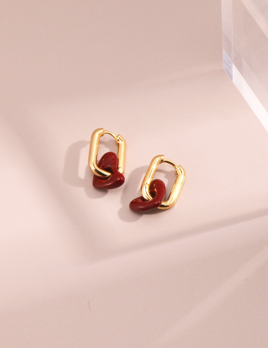Gold plated hoop earrings with red enamel heart stones.