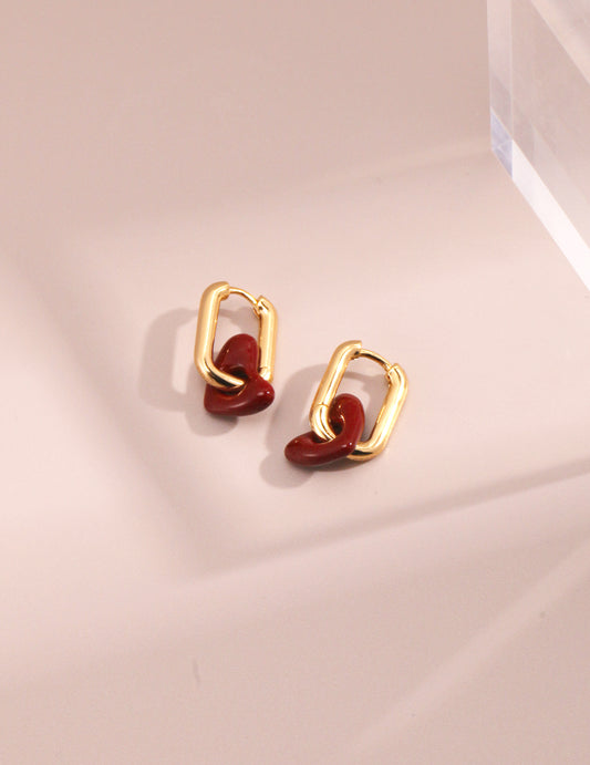 Gold plated hoop earrings with red enamel heart stones.