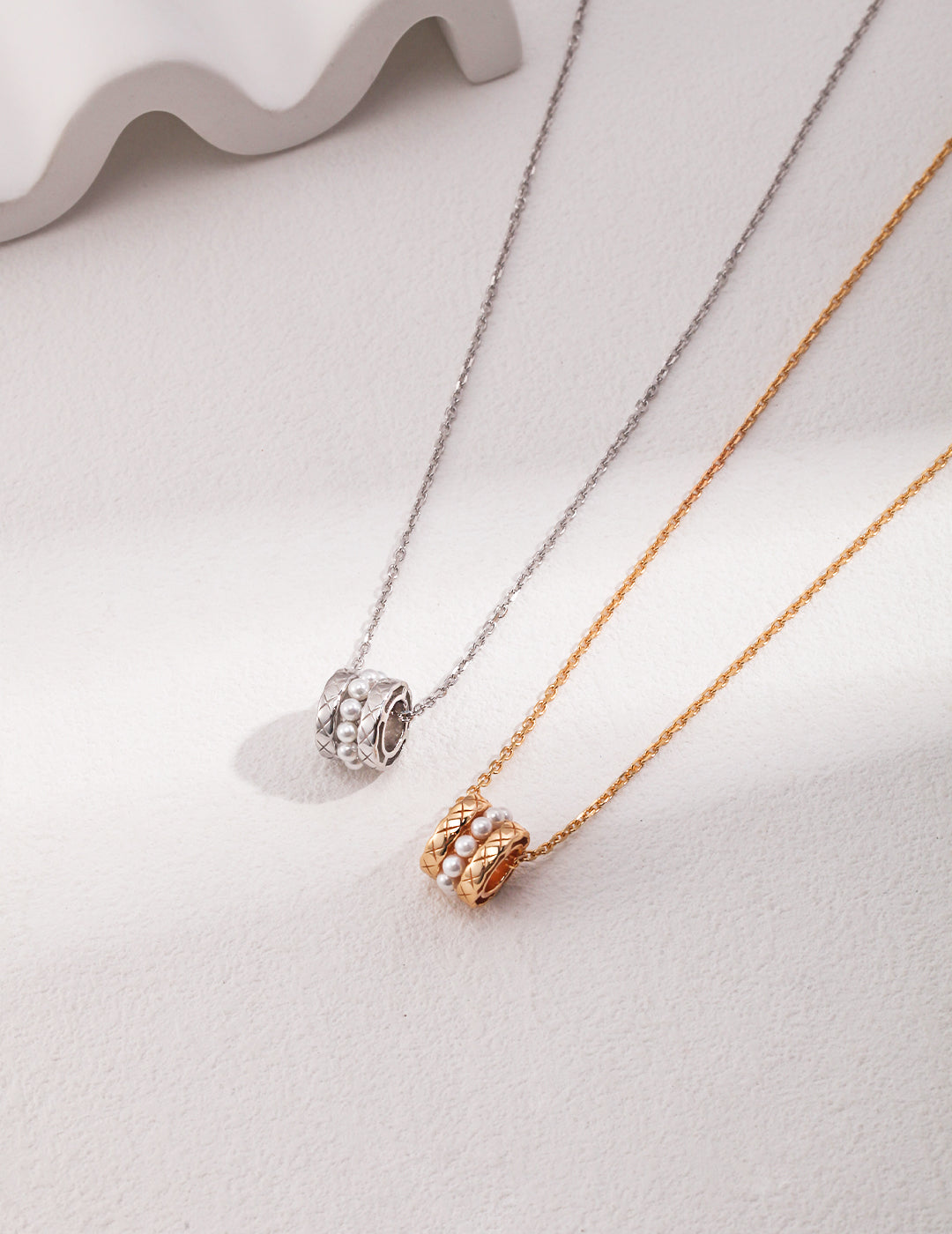 Stunning necklaces: one silver with pearl beads, one gold with pearl beads, both exquisite.