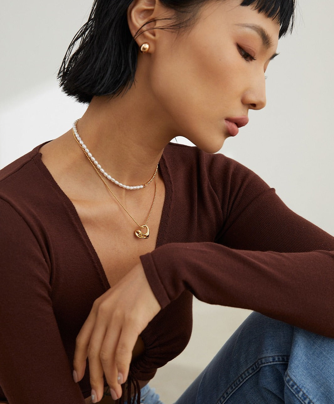 Fashionable woman accessorized with gold jewelry.