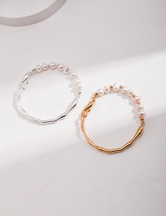 Stylish bangles with pearls, one half gold plated and the other half freshwater pearls bracelet, the other bangle in silver.