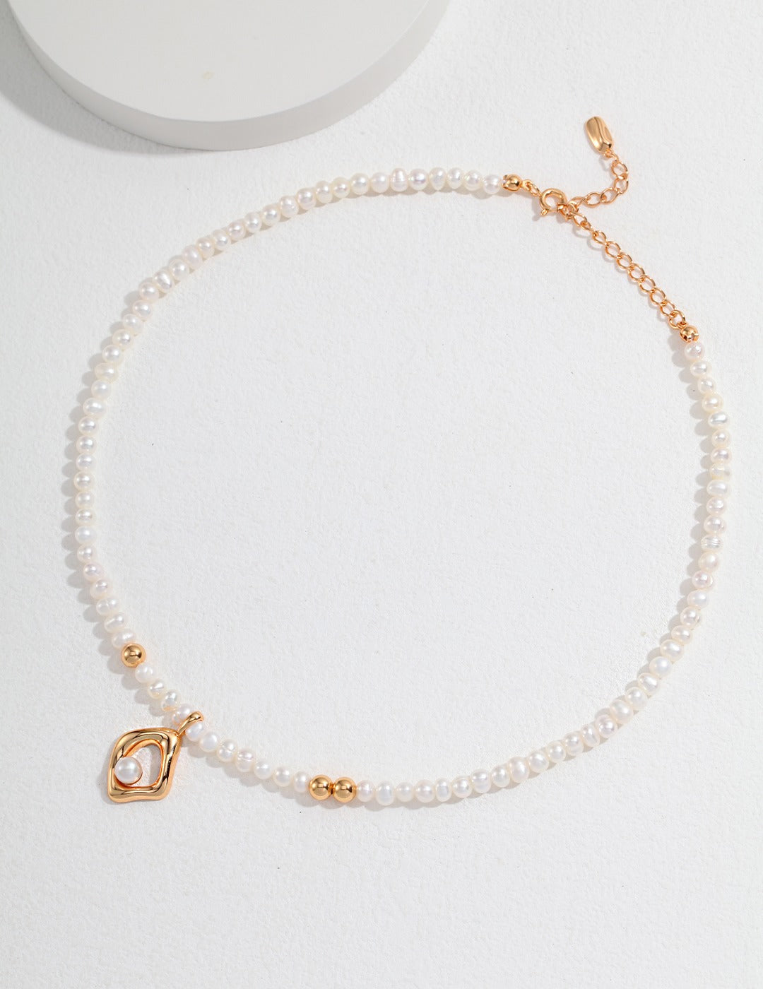 Stylish gold plated charm on pearl necklace