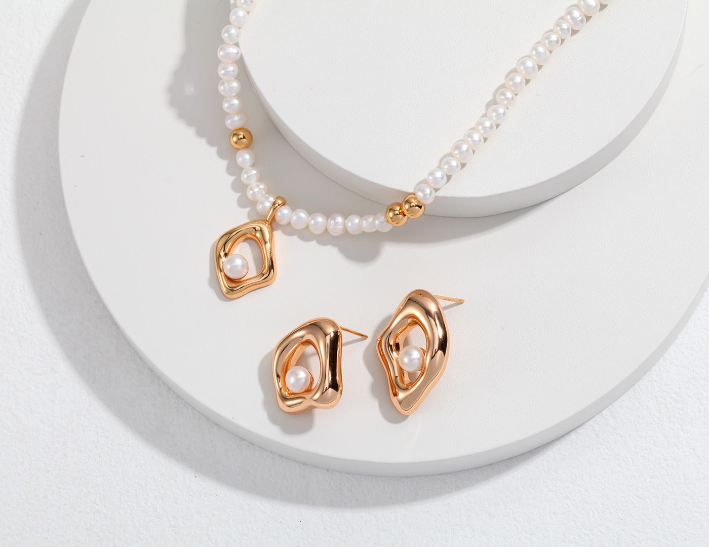 A stunning gold necklace and earrings set adorned with freshwater pearls, perfect for any elegant occasion.