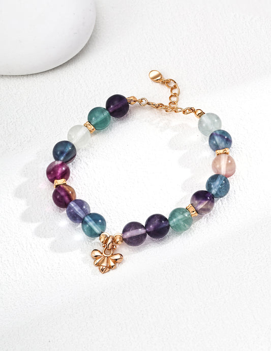 Multi-colored fluorite bracelet adorned with a gold-plated charm, offering a bright and eye-catching accessory.