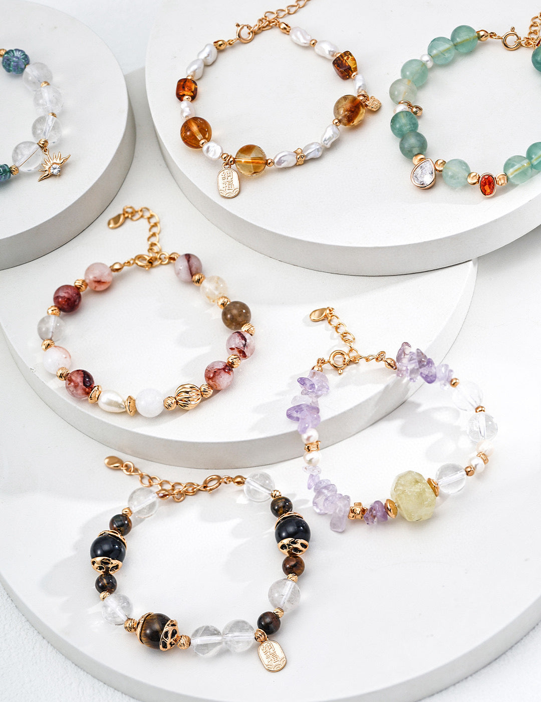 Set of colorful beaded bracelets on a white surface, featuring an assortment of colors and patterns.