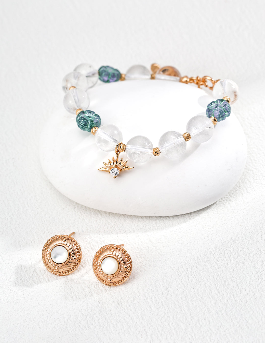 Jewelry set with a bracelet and earrings, showcasing clear quartz beads, flower glass beads, and a bee motif.