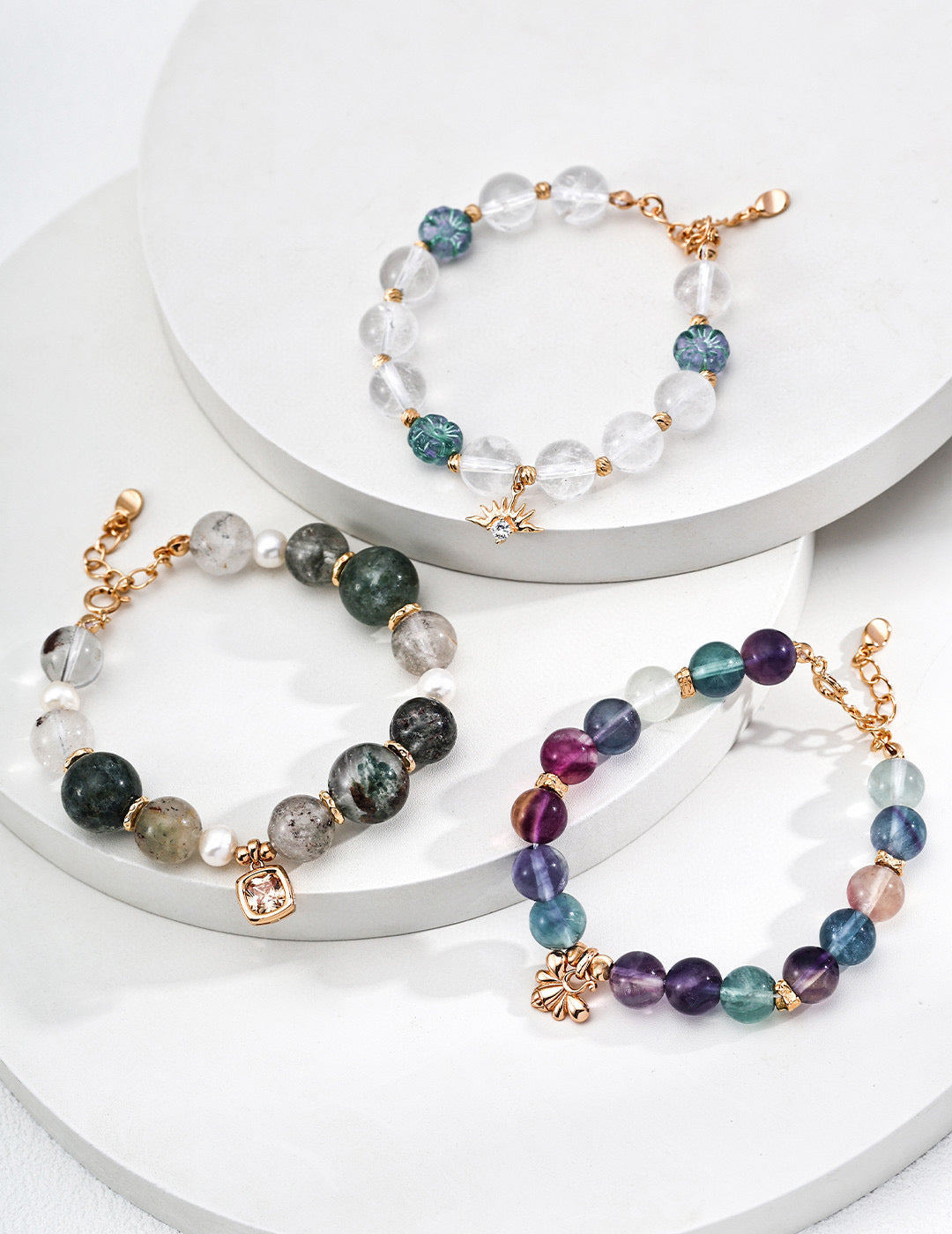 A trio of bracelets adorned with different colored stones, each displaying a distinct and colorful pattern.