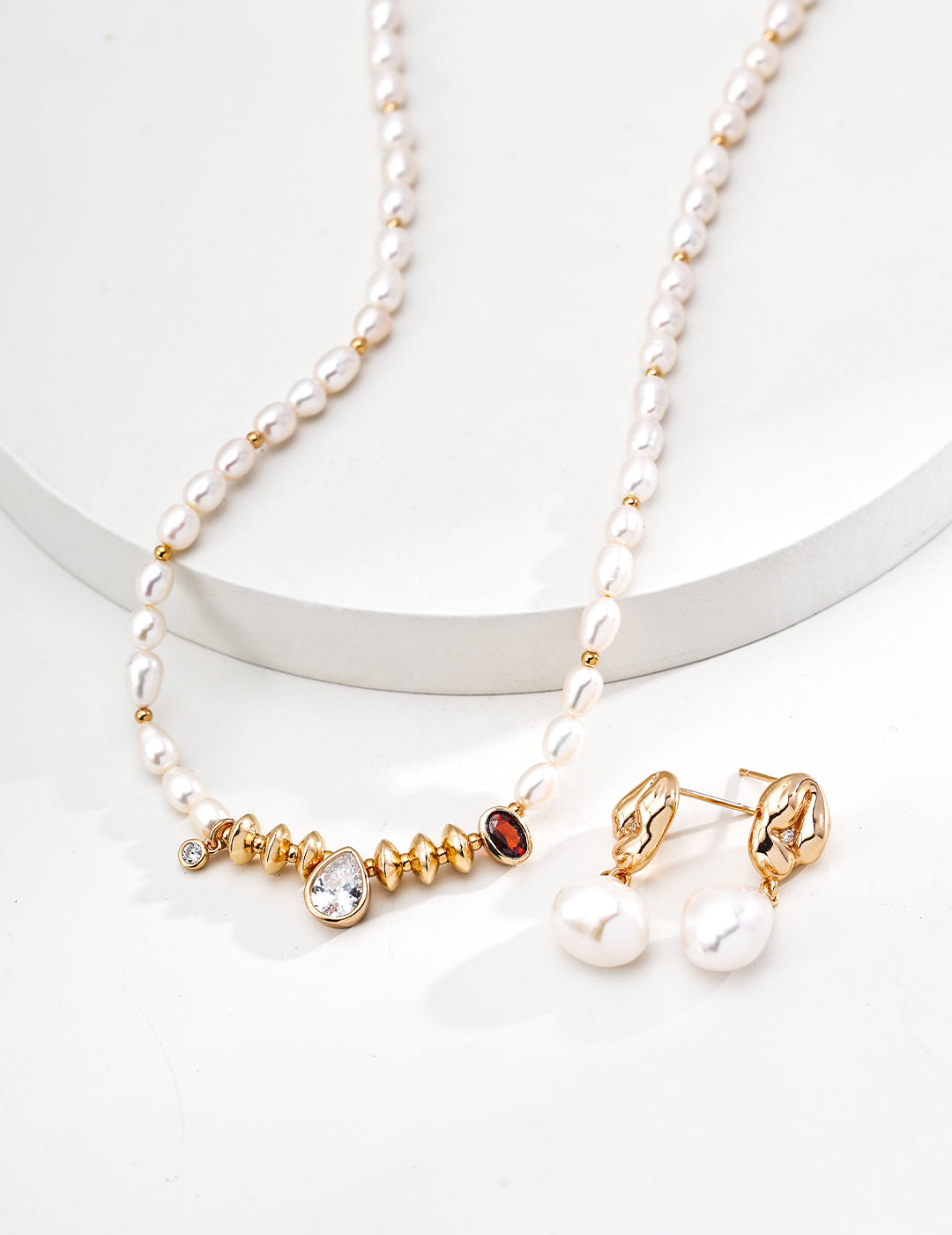 Elegant white pearl necklace and teardrop earrings with cubic zirconia, exuding a royal vibe.