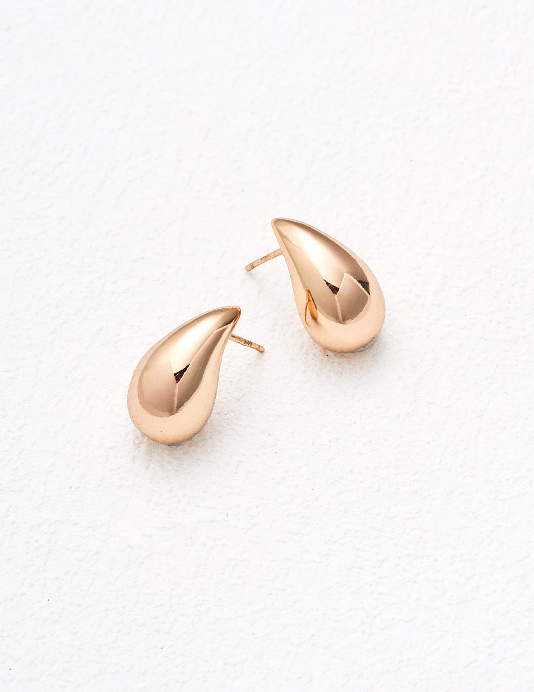 Gold teardrop earrings for a chic look.