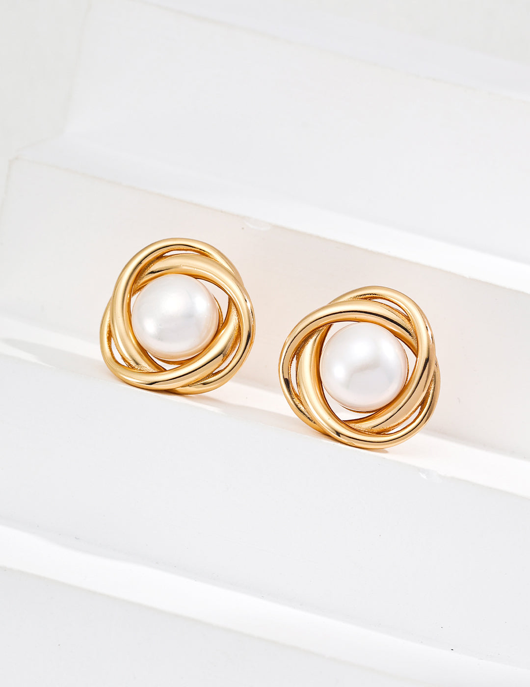 Chic gold tone pearl stud earrings, ideal for elevating everyday wear or special occasions with elegance.