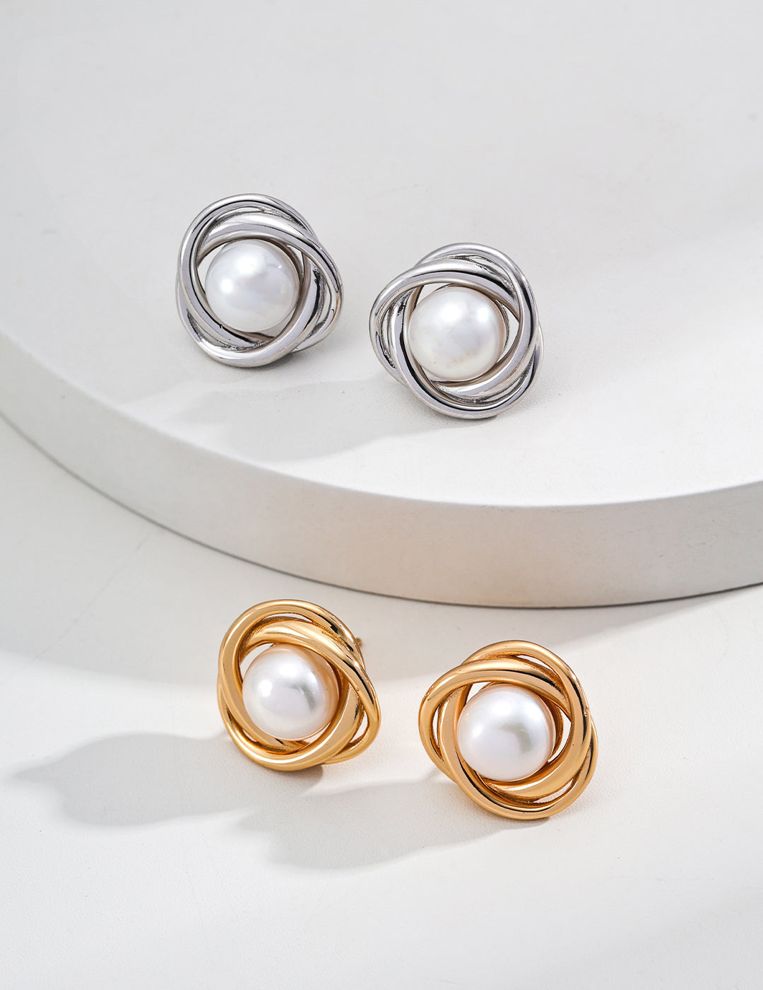 Beautiful gold and white pearl stud earrings, showcasing a classic design, available in silver and gold variations.