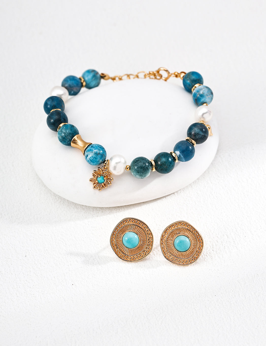 Beautiful jewelry set with a bracelet and earrings, featuring turquoise beads, azurite, and freshwater pearls for a chic look.