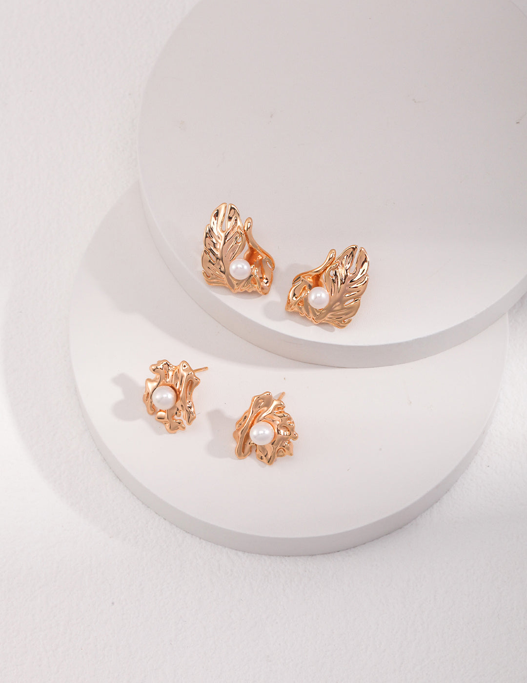 Two pairs of stylish gold-plated earrings with beautiful leaf accents, ideal for enhancing any outfit with a natural flair.