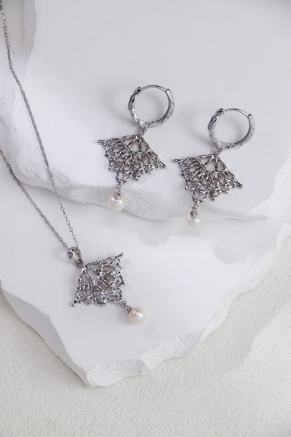 Beautiful pearl drop earrings paired with a matching necklace, creating a chic and refined look for special events.