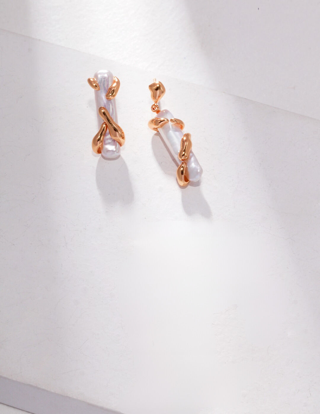 Elegant gold earrings featuring unique pearl design.