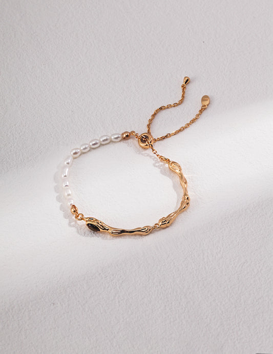 Gold plated bangle with pearl and gold chain, featuring freshwater pearls and tiger's eye centerpiece.