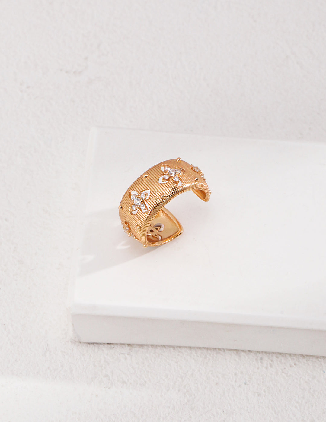 A stunning gold ring with an intricate diamond design, radiating elegance and sophistication.