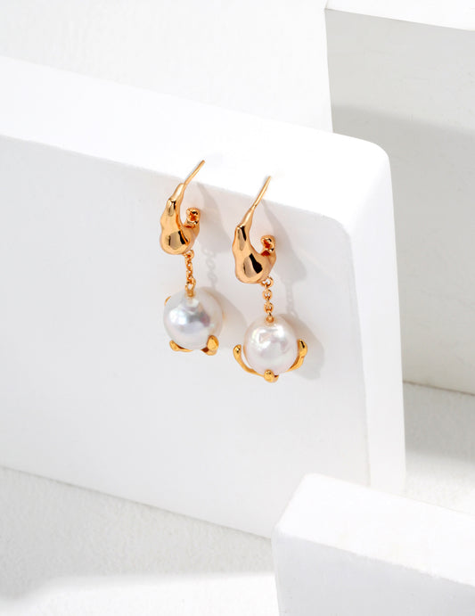 Stunning gold-plated earrings with gracefully suspended pearls, ideal for enhancing your jewelry collection.