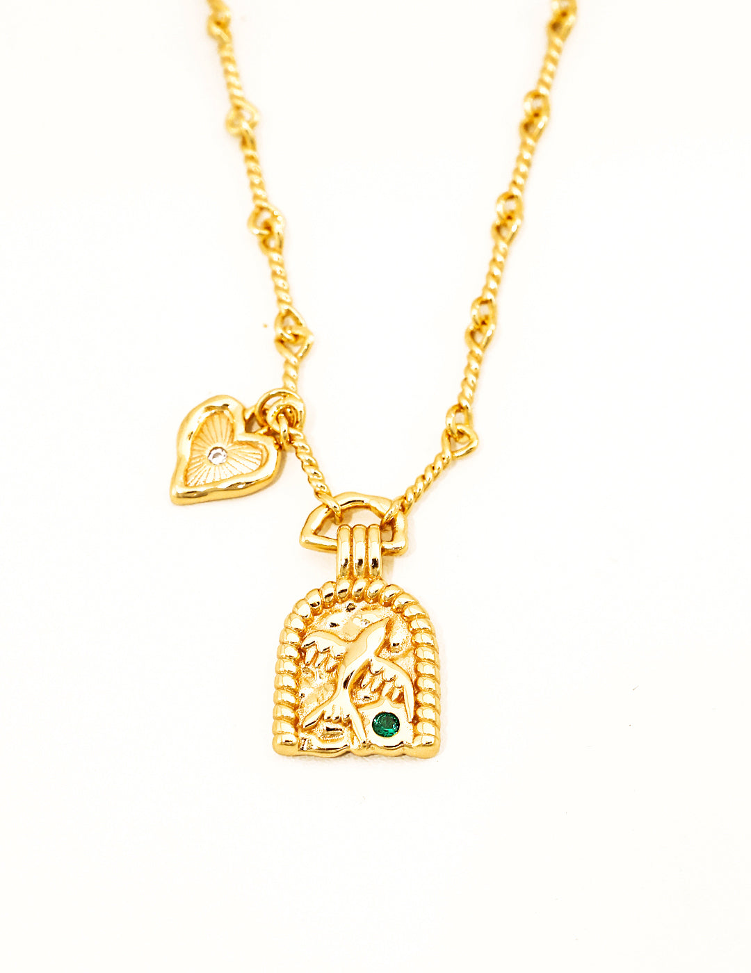 Gold chain necklace with heart charm and bird engraved charm.