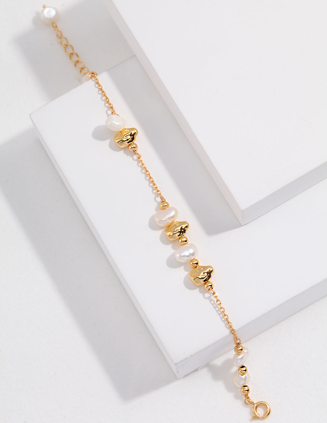 Delicate gold chain bracelet with lustrous freshwater pearls. Perfect blend of elegance and sophistication.