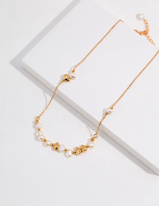 Gold plated necklace with a beautiful pearl pendant and a delicate chain made of freshwater pearl beads and gold.