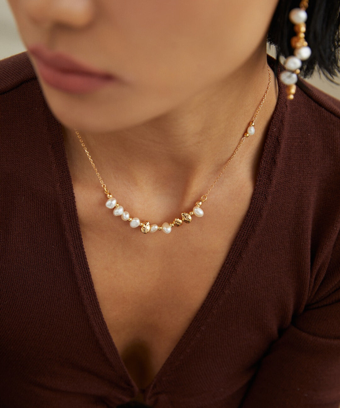 Woman in gold plated freshwater pearl beads necklace and matching earrings.