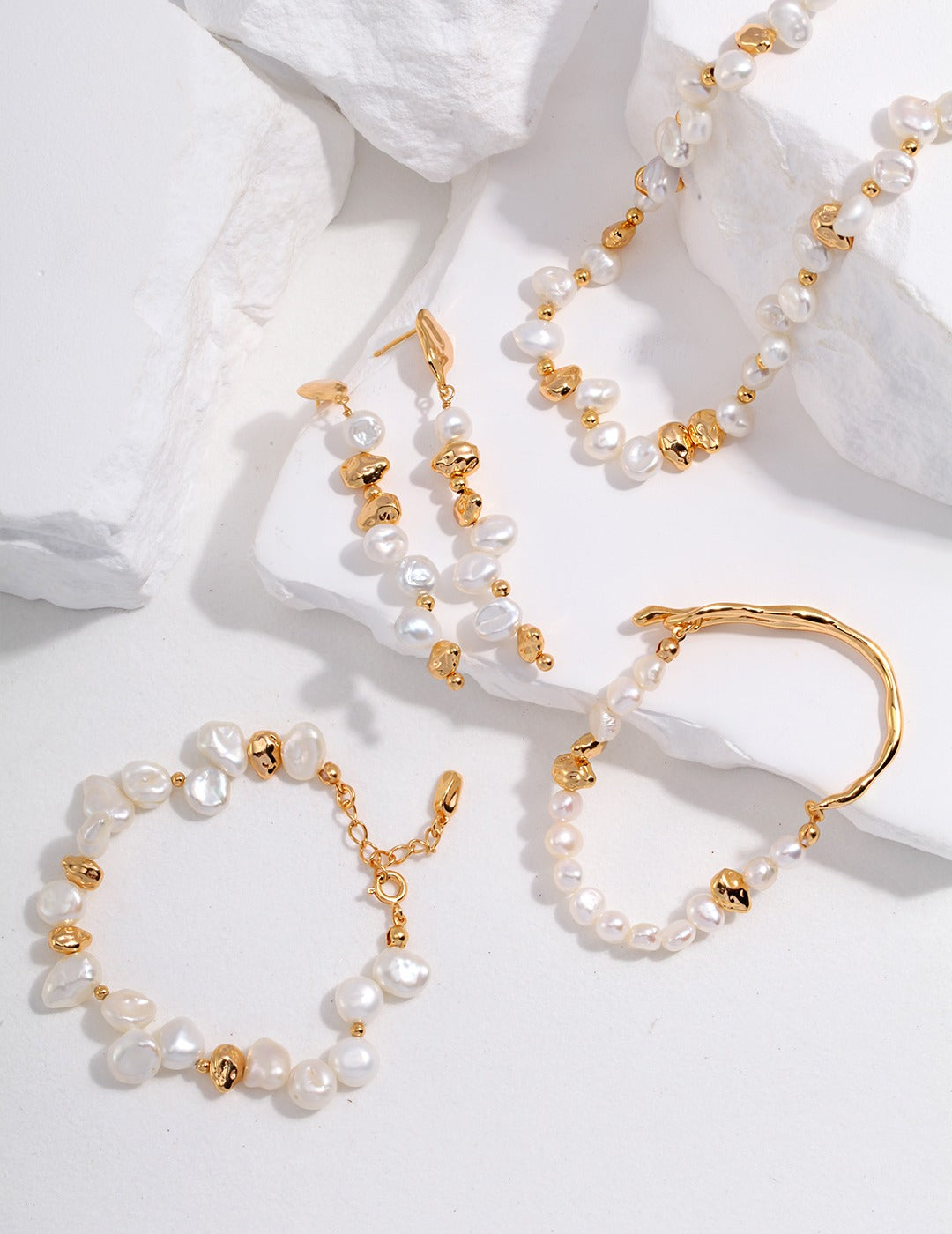  Stunning pearl-accented gold necklace, bracelet, and earrings set.