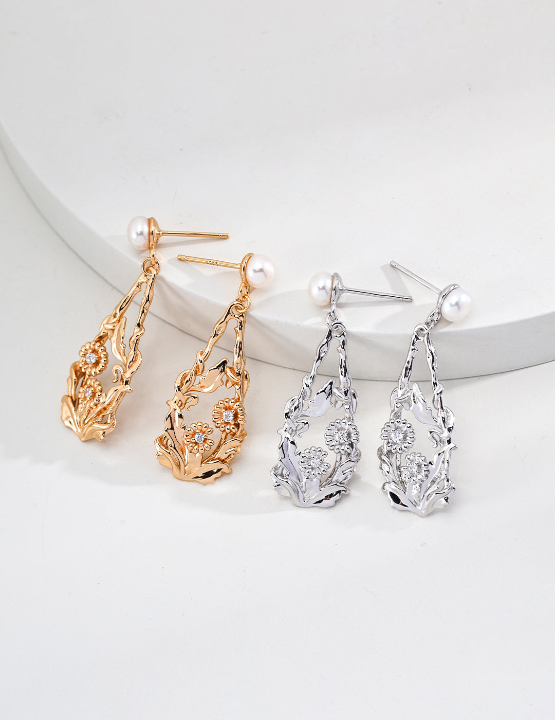 Two distinct pairs of earrings in different colors, each embellished with pearls, perfect for adding flair to any outfit.