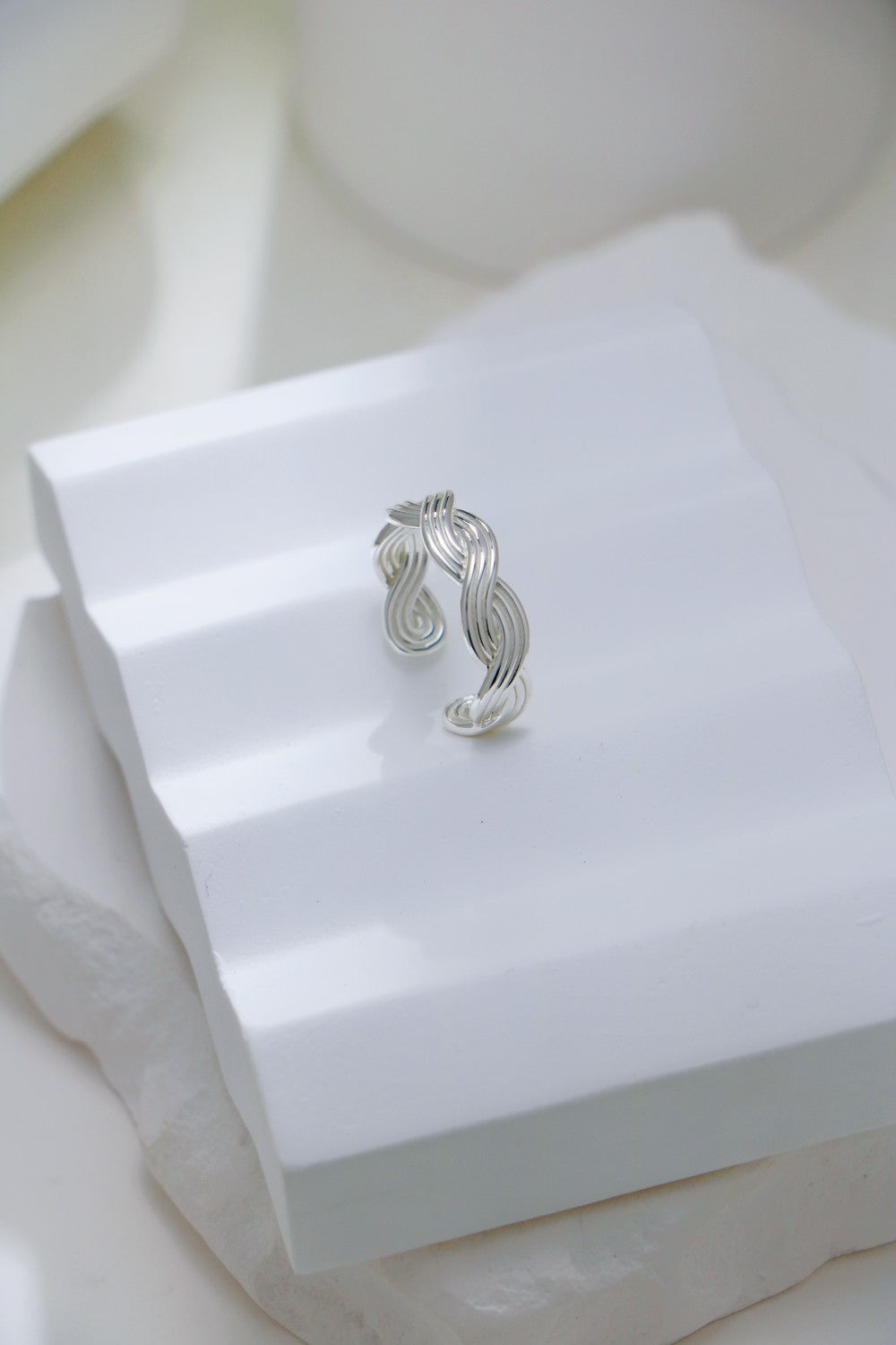 Elegant silver braid ring with a unique wave design, perfect for adding a touch of sophistication to any outfit.