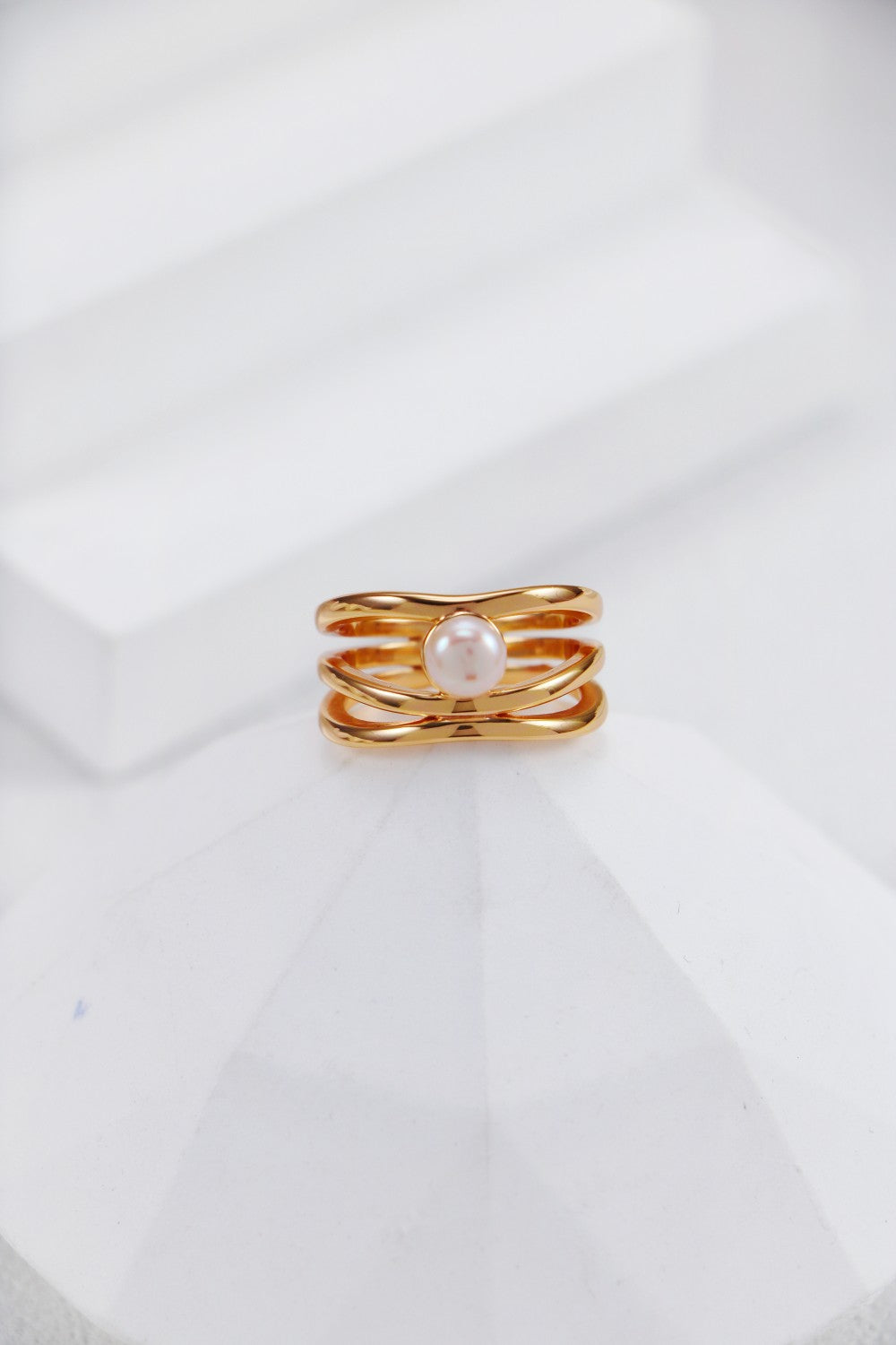 Elegant gold ring adorned with a beautiful pearl, showcasing a classic and refined style.