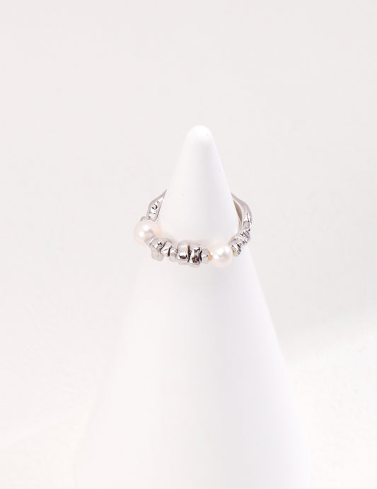 A silver ring with a lustrous pearl atop, showcasing elegance and sophistication. Perfect for any occasion.