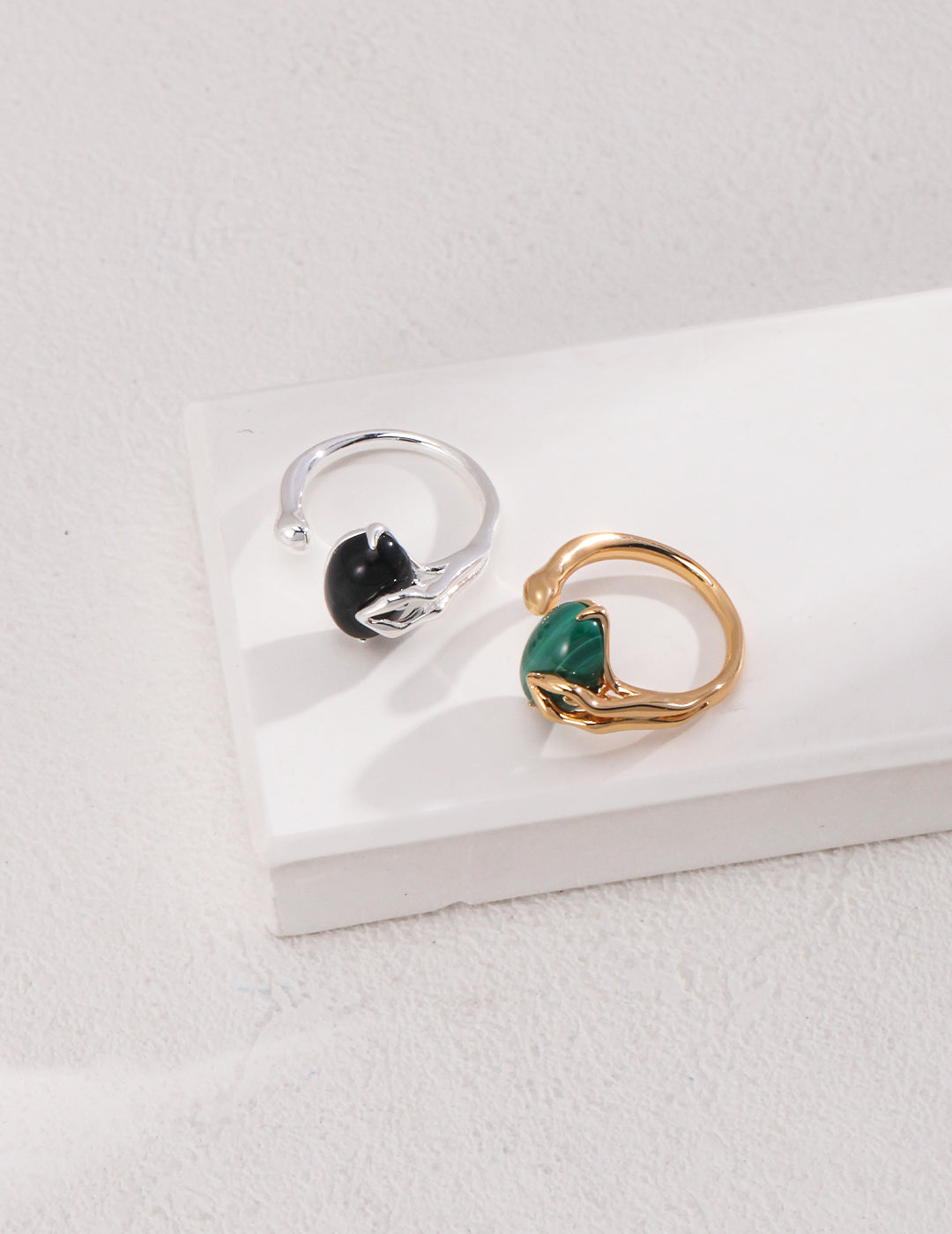 Stylish silver and gold rings adorned with black agate and malachite.